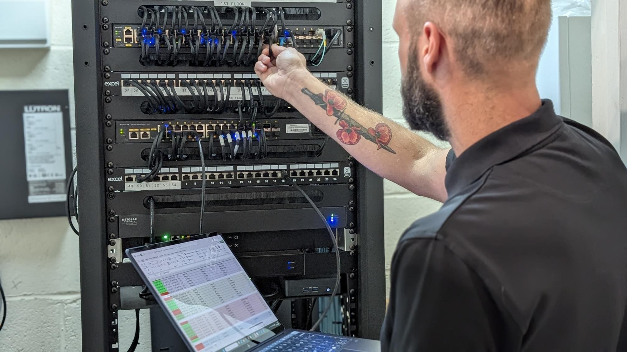 man standing in front of a laptop computer